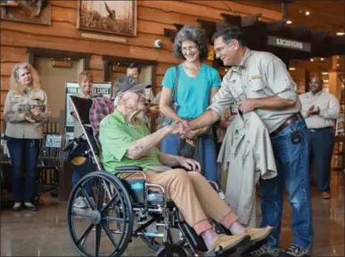  ?? ERIC BONZAR — THE MORNING JOURNAL ?? Cabela’s Marketing Manager Gary Gerrone presents 89-year-old Albert Janosik, of Amherst, with his very own, personaliz­ed, Cabela’s Outfitter uniform, Sept. 27. Janosik, a resident of Crossroads Hospice in Avon, was ceremoniou­sly sworn in as an official...