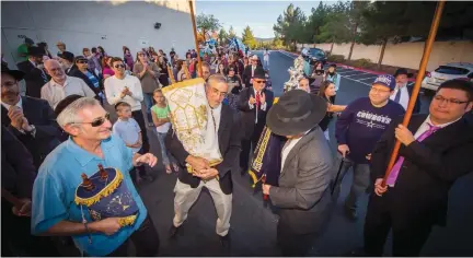  ?? (Courtesy Ahavas Torah Center) ?? MEMBERS OF the Ahavas Torah Center in Henderson, Nevada, parade through the city during a Torah dedication ceremony in the mid2010s.