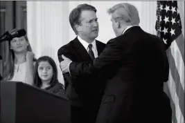 ?? ASSOCIATED PRESS ?? PRESIDENT DONALD TRUMP SHAKES HANDS WITH BRETT KAVANAUGH, his Supreme Court nominee, in the East Room of the White House on Monday in Washington.