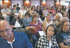  ?? Stephanie Strasburg/Post-Gazette ?? Pam Duricic, center, 59, born and raised in California, Pa., speaks passionate­ly during a town council meeting Thursday addressing the new population of immigrants from Romania in the town at the California Municipal Building.