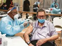  ?? Mark Mulligan / Staff photograph­er ?? Resident Jack Shipler receives the Pfizer vaccine in December at Avanti Senior Living at Town Lake in Cypress.