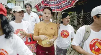  ?? — Reuters ?? Khine Mar Htay (C), a candidate from the NLD, and her party members campaign for the upcoming general election, in Yangon on Tuesday.