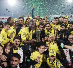  ??  ?? LAHORE: Cricketers of Peshawar Zalmi celebrate their victory over Quetta Gladiators in the final cricket match of the Pakistan Super League (PSL) at The Gaddafi Cricket Stadium in Lahore on Sunday. — AFP