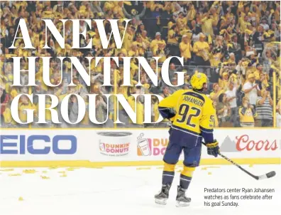  ??  ?? Predators center Ryan Johansen watches as fans celebrate after his goal Sunday.