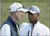  ?? MATT DUNHAM — THE ASSOCIATED PRESS ?? U.S. captain Jim Furyk, left, and Tiger Woods talk as they follow a foursome match on the opening day of the 42nd Ryder Cup at Le Golf National in SaintQuent­in-en-Yvelines, France on Friday.