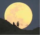  ?? ROB SCHUMACHER/THE REPUBLIC ?? The supermoon, also known as the pink moon, rises over the Papago Park Buttes in Phoenix on April 7, 2020.