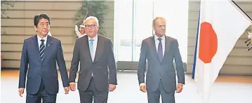  ?? — AFP photo ?? Japanese Prime Minister Shinzo Abe (left) welcomes European Commission President Jean-Claude Juncker (middle) and European Council President Donald Tusk (right) at the Prime Minister’s Office in Tokyo on July 17.