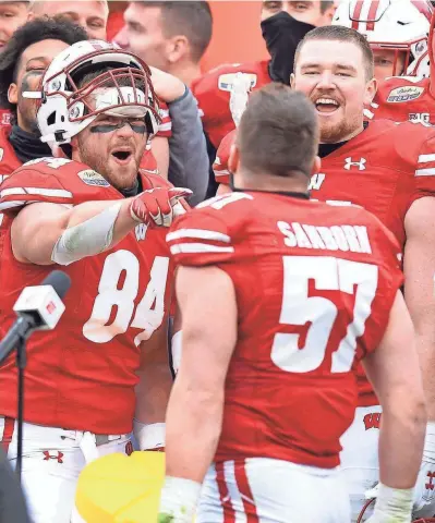  ?? AP ?? Wisconsin linebacker Jack Sanborn is greeted by his teammates after being named the MVP of the Duke’s Mayo Bowl following their victory over Wake Forest on Wednesday. Sanborn had 11 tackles and an intercepti­on.