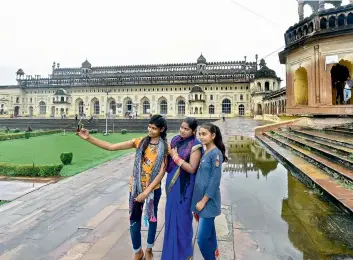  ?? —PTI ?? Visitors get a selfie clicked at Bara Imambara in Lucknow on Thursday as the monument reopens after a gap of more than six months owing to Coronaviru­s related lockdown.