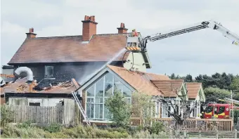  ??  ?? Firefighte­rs at work at the scene.