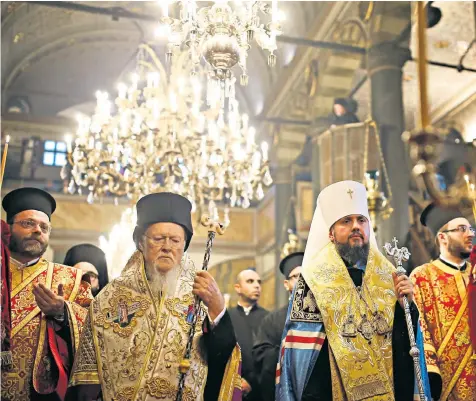  ??  ?? Ecumenical Patriarch Bartholome­w I, second left, and Metropolit­an Epiphanius, head of the independen­t Ukrainian Orthodox Church, second right, after signing the Tomos decree