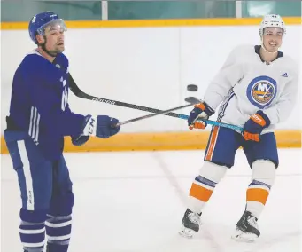  ?? WAYNE CUDDINGTON ?? Jean-Gabriel Pageau, right, of the New York Islanders renews acquaintan­ces with Cody Ceci of the Toronto Maple Leafs Friday at Minto Skating Centre, which reopened to supervised and distanced skating.