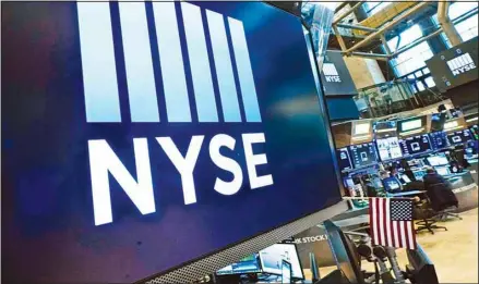  ?? ?? Logos the New York Stock Exchange adorn trading posts, on the floor, Wednesday, March 16, 2022. Stocks are off to a strong start on Wall Street, Thursday, April 21 as traders cheer strong earnings reports from several big U.S. companies. (AP)