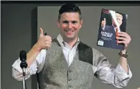  ?? ASSOCIATED PRESS FILE PHOTO ?? Richard Spencer, who leads a movement that mixes racism, white nationalis­m and populism, holds up a magazine cover showing President-elect Donald Trump before signing it for a supporter Dec. 6 in College Station, Texas. On Monday, Texas A&M University...