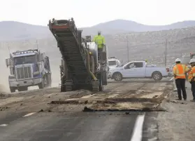  ?? Marcio Jose Sanchez / Associated Press ?? Road crews work on repairing a section of State Route 178 Sunday near Trona (San Bernardino County) following the two earthquake­s that hit last week.