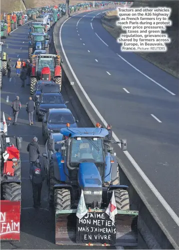  ?? Picture: REUTERS ?? Tractors and other vehicles queue on the A16 highway as French farmers try to reach Paris during a protest over price pressures, taxes and green regulation, grievances shared by farmers across Europe, in Beauvais, France.