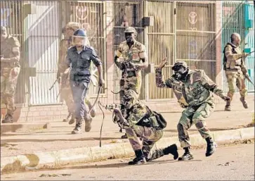  ?? Zinyange Auntony AFP/Getty Images ?? A SOLDIER fires at demonstrat­ors in Harare, Zimbabwe. Opposition protesters have accused the government of manipulati­ng the presidenti­al election. Official electoral results are expected Saturday.