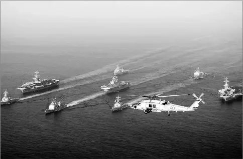  ??  ?? This file handout released by the US Navy shows the USS John C Stennis, the USS Nimitz, and the USS Bonhomme Richard along with USS Antietam, USS O’Kane, USS Higgins, USS Denver and USS Rushmore steaming through the Gulf of Oman. — AFP photo
