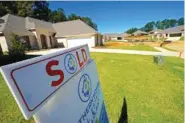  ?? AP PHOTO/ROGELIO V. SOLIS ?? In 2021, a “Sold” sign decorates the lawn of a new house in Pearl, Miss.