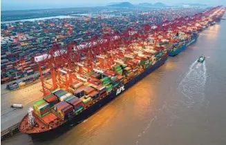  ?? JI HAIXIN / FOR CHINA DAILY ?? Container vessels being loaded at Yangshan Port, Shanghai.