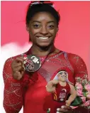  ??  ?? Simone Biles with her gold medal after the floor exercise at the Worlds