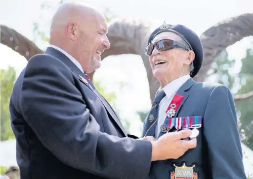  ??  ?? ●Alfred Barlow, right, is presented with the replacemen­t medals (right) by fellow veteran Alan Walker