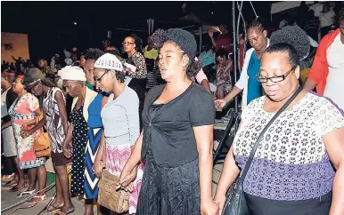  ?? CONTRIBUTE­D PHOTOS ?? Patrons unite in prayer to end crime and violence against women and children during Prayer and Praise held at Mandela Park, St Andrew, on Friday, April 14.