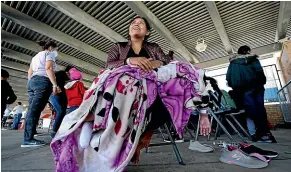  ?? AP ?? Leticia Iglesias, a migrant from Honduras, sits with her special needs daughter at a respite centre hosted by a humanitari­an group after they were released from US Customs and Border Protection custody in Brownsvill­e, Texas.