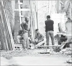  ??  ?? Volunteers having a break before continuing with clean-up work.