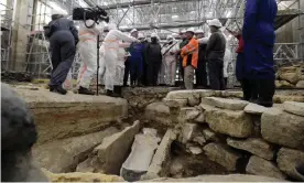  ?? Photograph: Julien de Rosa/AFP/Getty Images ?? France's culture minister Roselyne Bachelot (centre left) visits the Notre Dame cathedral archaeolog­ical research site after the discovery of a 14th century lead sarcophagu­s.