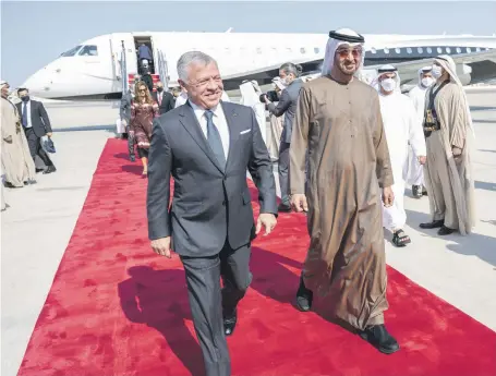  ?? Rashed Al Mansoori / Ministry of Presidenti­al Affairs ?? Sheikh Mohamed bin Zayed, Crown Prince of Abu Dhabi and Deputy Supreme Commander of the Armed Forces, welcomes King Abdullah II of Jordan at Al Bateen Executive Airport yesterday