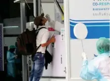  ?? Photo: PR Phuket ?? A tourist undergoes a swab test after arriving at Phuket airport.