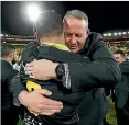  ??  ?? Wellington head coach Chris Gibbes shared a hug with prop Alex Fidow.