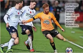  ?? ?? Cambridge United’s James Brophy looks to get in a cross against Bolton Wanderers.