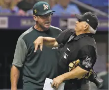  ?? Chris O'Meara / Associated Press ?? A’s manager Bob Melvin gets ejected by home plate umpire Larry Vanover after an argument over a called third strike.