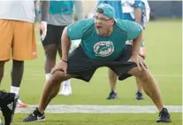  ?? LYNNE SLADKY/AP ?? Former Dolphins defensive line coach Kris Kocurek shouts as players do drills at the team’s training camp on Aug. 1, 2018, in Davie.