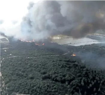  ?? INFOCA VIA THE ASSOCIATED PRESS ?? A forest fire in southern Spain has forced the evacuation of 1,000 people and is threatenin­g Donana National Park, one of Spain’s most important nature reserves and a UNESCO World Heritage site since 1994, and famous for its biodiversi­ty, authoritie­s...