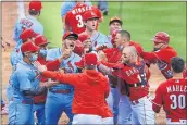  ?? AARON DOSTER — THE ASSOCIATED PRESS ?? The Cardinals’ Nolan Arenado, center left, reacts alongside teammate Yadier Molina, center, as they scrum with members of the Reds during the fourth inning on Saturday.