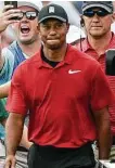  ?? John Amis / Associated Press ?? As fans cheered, a triumphant Tiger Woods struggled to keep his emotions in check as he approached the 18th green.