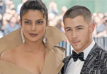  ??  ?? Hollywood’s Nick Jonas has confirmed his engagement to Bollywood superstar Priyanka Chopra (left).