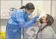  ?? (AP/Brynn Anderson) ?? Anderson receives a coronaviru­s test July 12 before resuming work at the Cannes Film Festival.