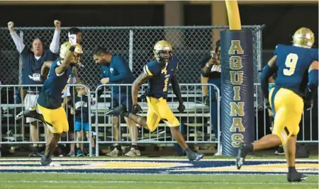  ?? JOHN MCCALL/SOUTH FLORIDA SUN SENTINEL ?? St. Thomas Aquinas defensive back King Mack celebrates after returning an intercepti­on for a touchdown against Jesuit during the first half of their 3M state semifinal on Dec. 2 in Fort Lauderdale.