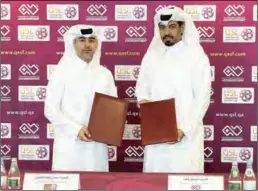  ?? ?? Hassan Rabiah Al Kuwari, Executive Director of Sales, Marketing and Communicat­ion at Qatar Stars League (QSL), and Faisal Khaled, Secretary-General of Qatar ESports Federation, during the agreement signing.