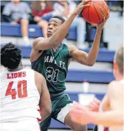  ?? [PHOTO BY BRYAN TERRY, THE OKLAHOMAN] ?? Edmond Santa Fe’s Colby Onyekuru moves to the basket during Tuesday’s high school basketball game in Moore.