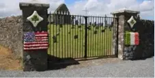  ??  ?? The gates to the cemetery were decorated in the American and Irish flags.