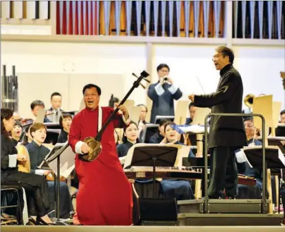  ?? PHOTOS PROVIDED TO CHINA DAILY ?? Zhao Taisheng joins a concert of the Hong Kong Chinese Orchestra, under artistic director and principal conductor Yan Huichang, in October 2013 in Yekaterinb­urg city of Russia.