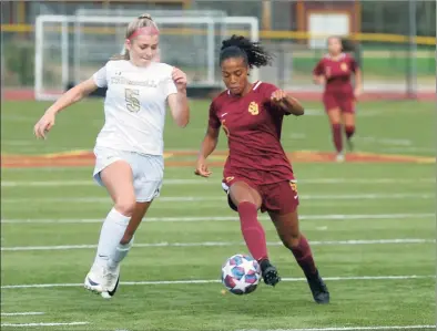  ?? Ned Gerard / Hearst Connecticu­t Media ?? Trumbull’s Lauren Mecca, left, and St. Joseph’s Laci Lewis chase the ball during Thursday’s girls soccer game.