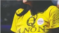  ?? ELIJAH NOUVELAGE / REUTERS ?? A supporter of U.S. President Donald Trump wears
a QAnon shirt in Georgia in September.