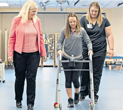  ??  ?? Kelly Thomas, who was injured in a car accident, was one of the first to benefit from the new therapy at the University of Louisville. She now walks on her own