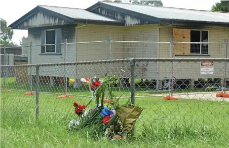  ?? Photo: Claudia Williams ?? SHOCK: A floral tribute outside the Kingaroy St, Kingaroy, home where Bruce Fisher and his two sons Connor and Bruce Jnr died in a tragic house fire on Saturday.